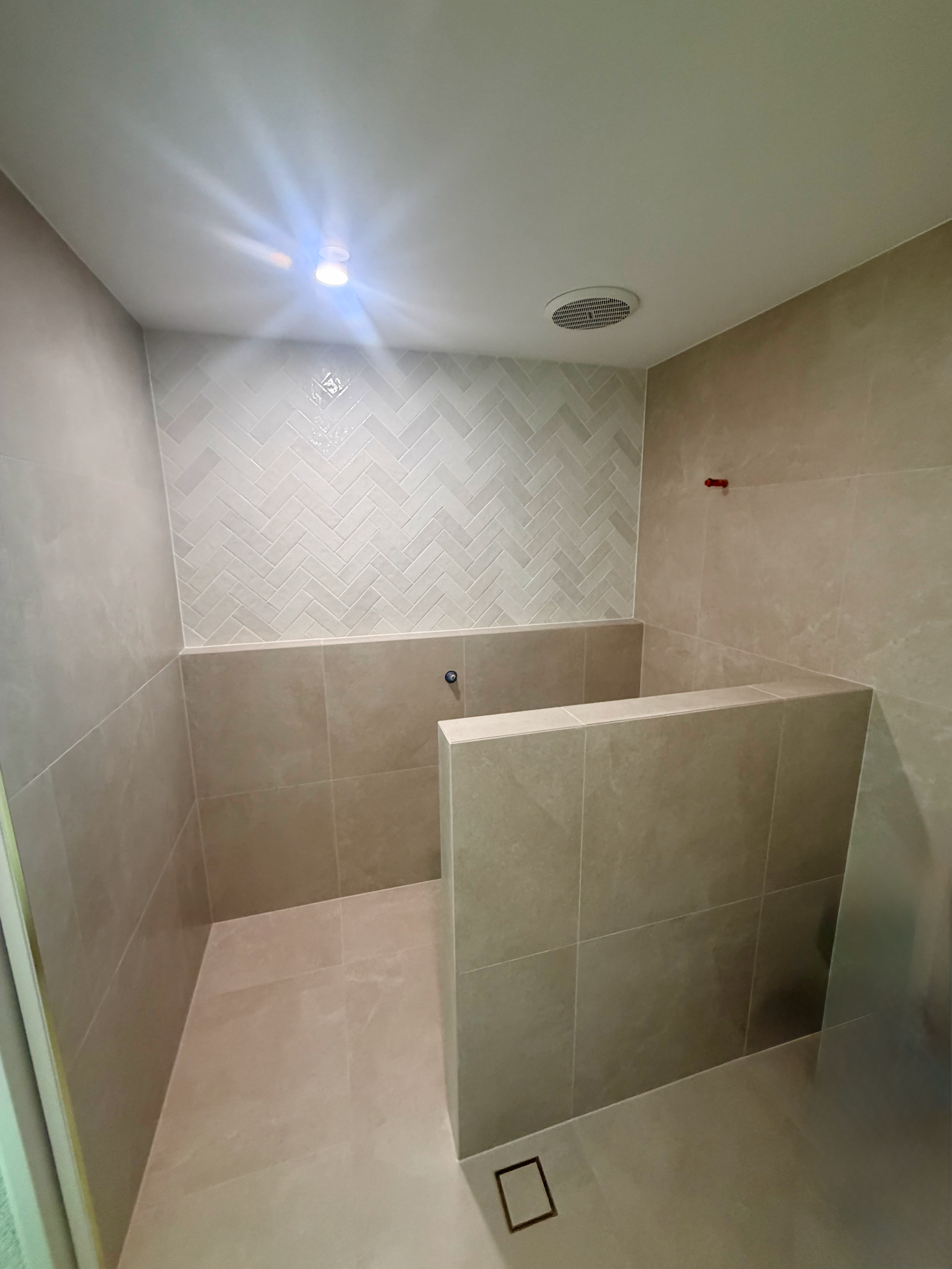 Stylish bathroom with geometric tile accents and floating vanity