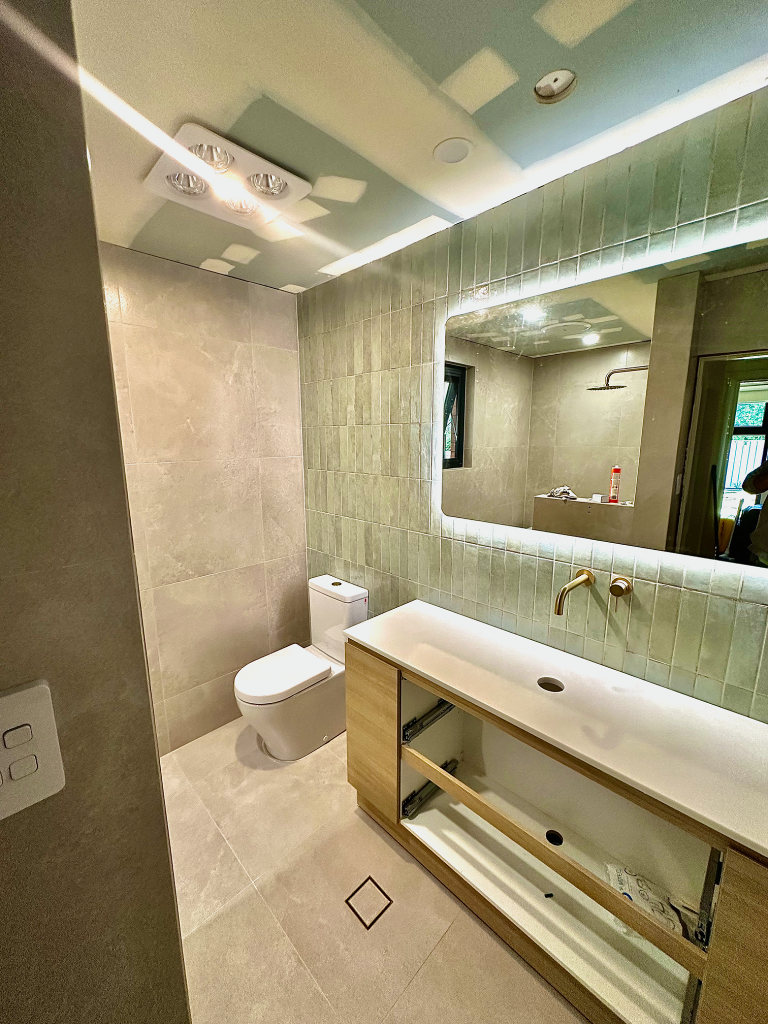 Finished bathroom with modern fixtures and patterned floor tiles